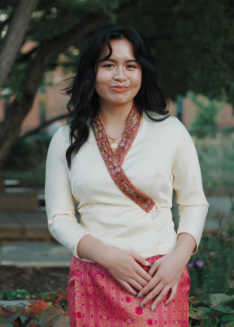 Headshot of Allison Siriouthay, smiling in a white blouse.