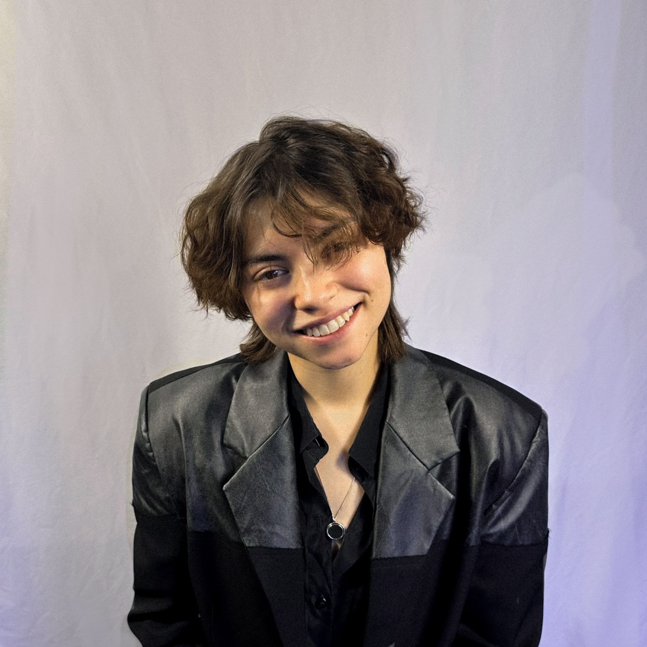 Headshot of Aimar Montes, smiling in a black jacket.