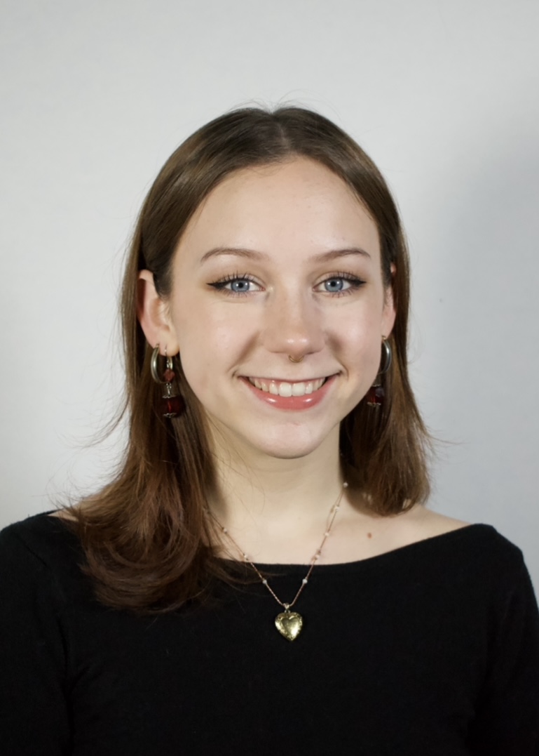 Headshot of Kailee Baumann, smiling in a black shirt.