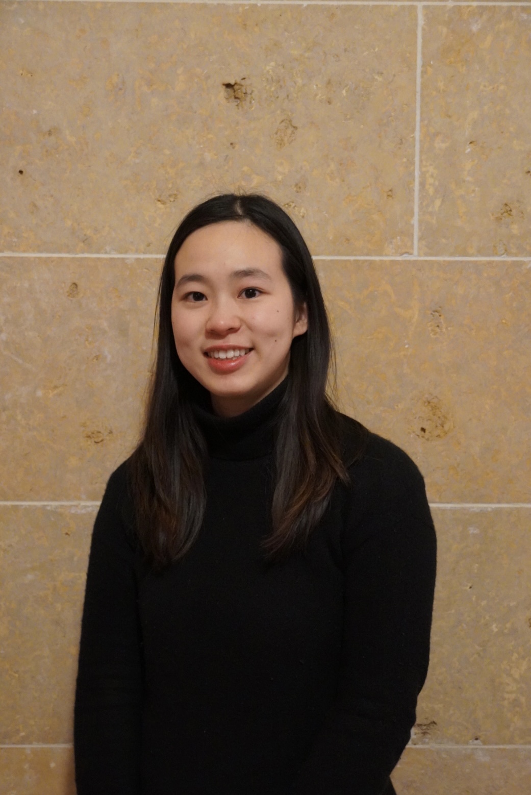 Headshot of Rosalind Ding, smiling in a black turtleneck shirt.