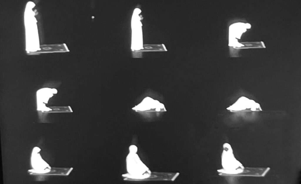 Samia Guled demonstrates the positions of prayer at the Regis Center for Art.