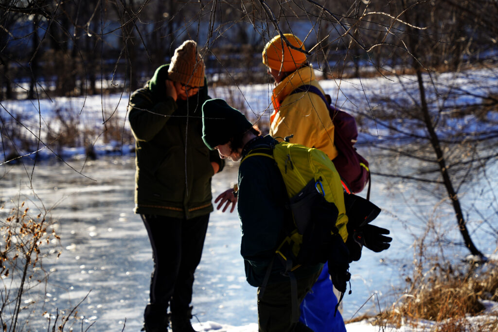Liz Perelman, Mark Hover and Jenna Grey Eagle are hoping to find wildlife tracks in the snow by the river in St. Paul on February 18, 2024.