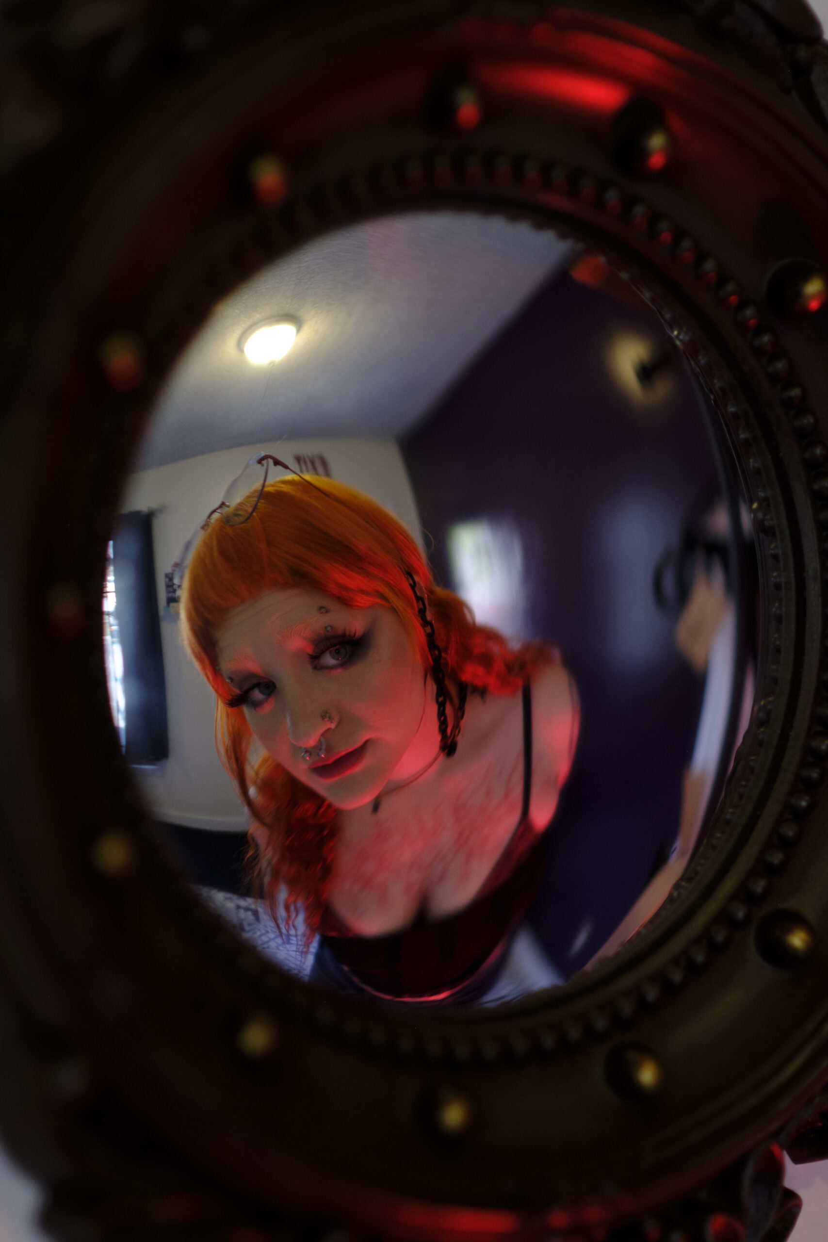 A person looking into the fisheye lens of a camera.